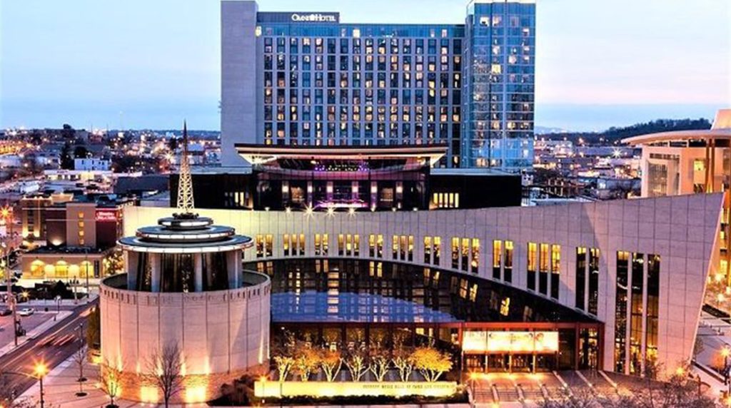 Country Music Hall of Fame Nashville twilight cityscape with Omni Hotel nearby, perfect for Nashville travel tips.